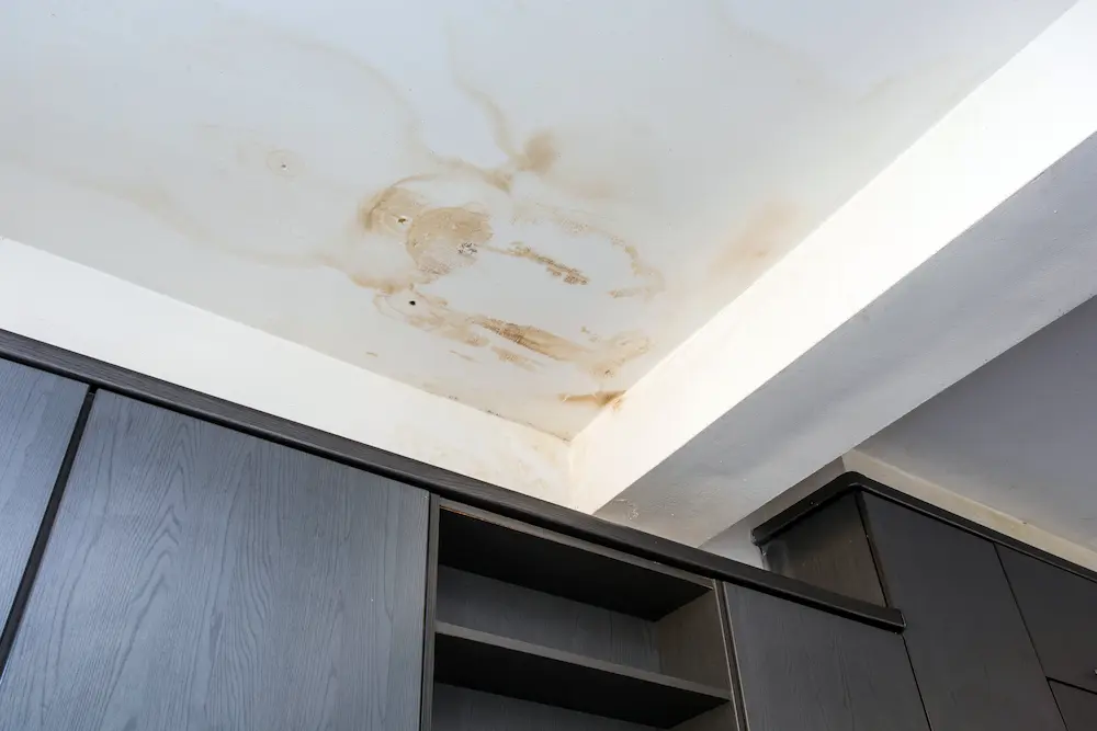 Water-damaged ceiling roof with a stain from roof leakage